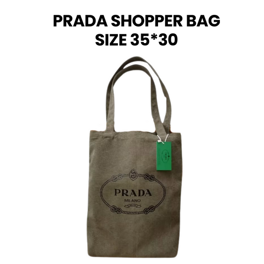 Prada shopper bag with a green tag on a white background